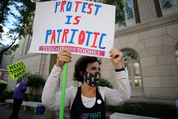 Liz Abrams-Morley protesting outside Sen. Pat Toomey’s office on the 200 block of Chestnut Street in Philadelphia in October 2020, the day after Toomey, a Republican, announced his retirement from the Senate.