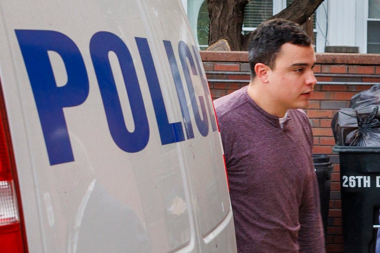 Philadelphia Police Officer Mark Dial enters the police district headquarters to face murder charges on Sept. 8.