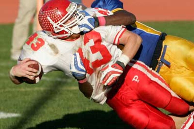 Paulsboro's Zach Greenwald (front) dives across the goal line as Woodbury's Dyshawn Davis (back) grabs onto his face mask for a penalty. (Tom Mihalek / Staff Photographer )