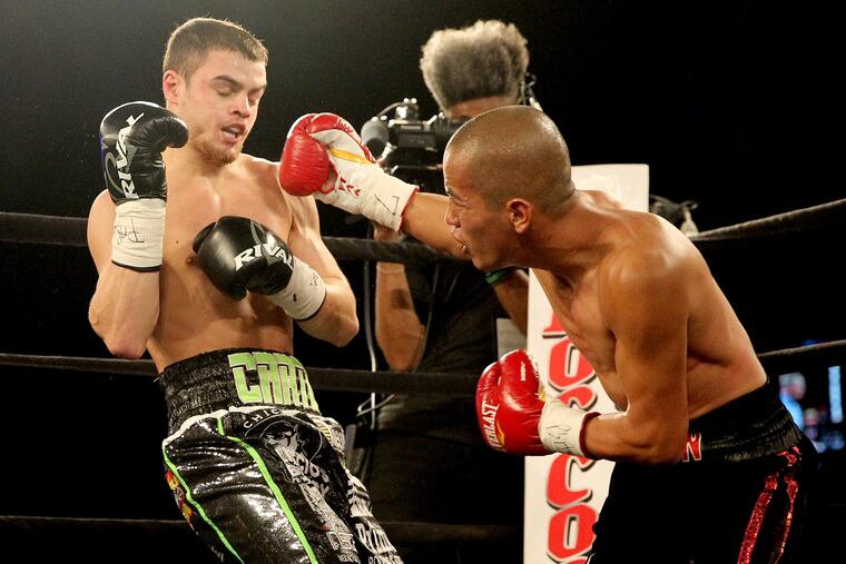 Christian Carto, left, takes a punch from Victor Ruiz in the first round Friday night.