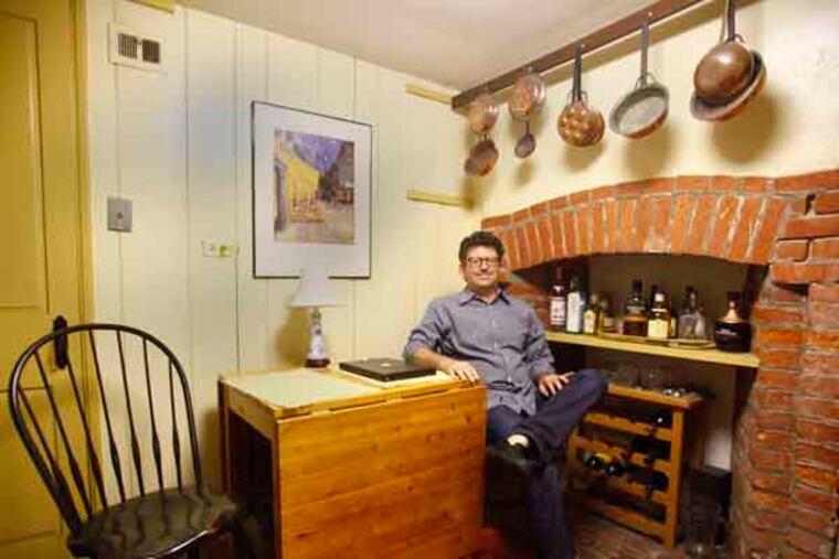 Paul Boni sits in the kitchen of his home in Bells Court in Society Hill on Wednesday afternoon. Hutelmyer, along with others, have found a way to live in these historic, small 681 square foot houses that were built back in the early 1800's. (LUKE RAFFERTY/Staff Photographer)