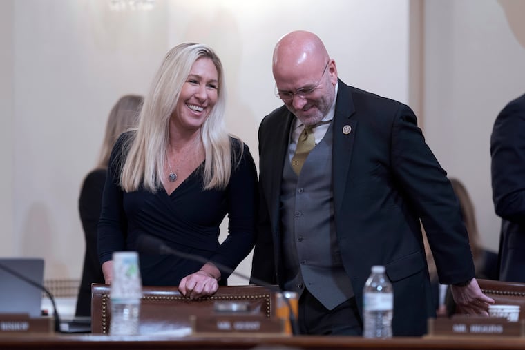 Rep. Marjorie Taylor Greene, R-Ga., left, and Rep. Clay Higgins, R-La., confer during a break as Republicans on the House Homeland Security Committee move to impeach Secretary of Homeland Security Alejandro Mayorkas over the crisis at the U.S.-Mexico border.
