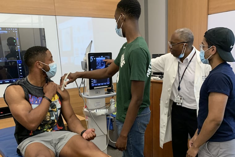 Dr. Horace DeLisser, a trustee of the College of Physicians of Philadelphia and associate dean for diversity and inclusion at Penn's Perelman School of Medicine, works with college students (from left) Bryson Houston, Lamina Diakho and Boby Daniel during a pilot session for the Hinkson Holloway Mentorship Program in 2022.