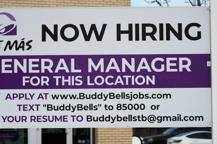 A hiring sign is displayed outside of a restaurant in Arlington Heights, Ill., on Wednesday.