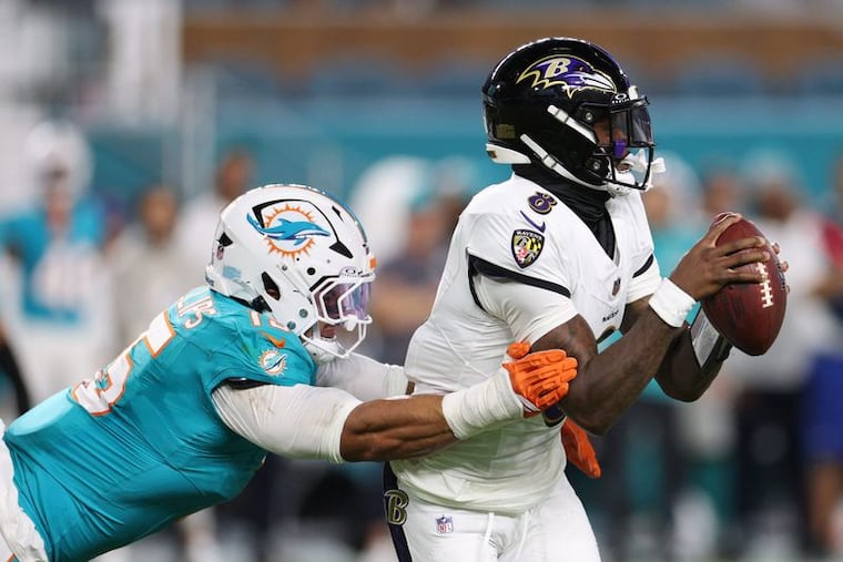 Dolphins linebacker Jaelan Phillips tackles Ravens quarterback Lamar Jackson on Oct. 30.