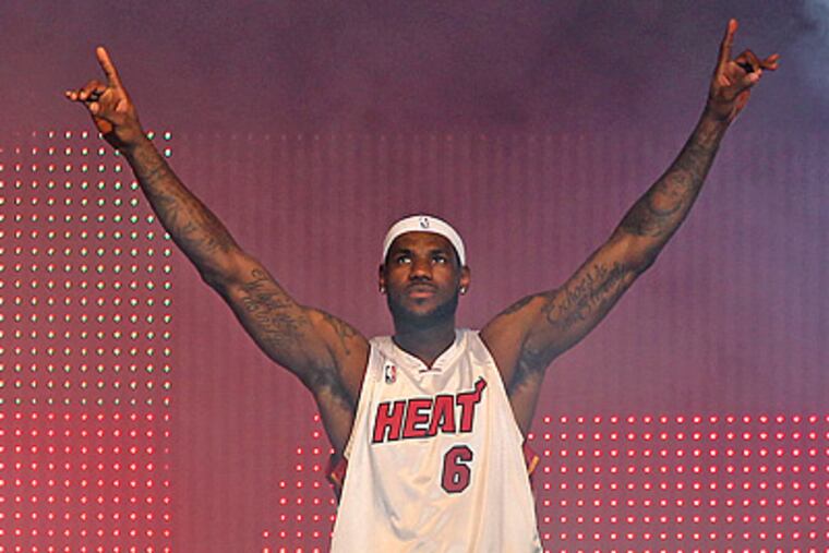 LeBron James enjoys the moment at an event at the American Airlines Arena in Miami. (AP Photo/Miami Herald, Al Diaz)