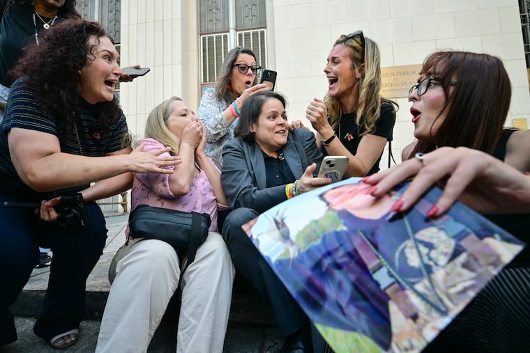 Laura Marquez-Garrett (center), plaintiffs’ attorney for Social Media Victims Law Center, gathers with family members of victims as they react to news that the jury has found Meta and YouTube liable in the social media addiction trial, outside the Los Angeles Superior Court in Los Angeles on March 25.