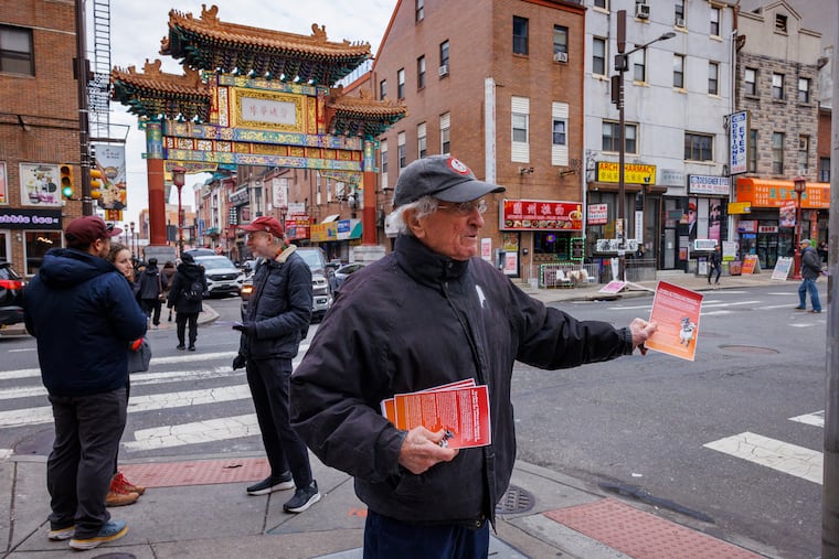 Harvey Finkle gives out fliers during a Christmas Day protest against the proposed Sixers arena.