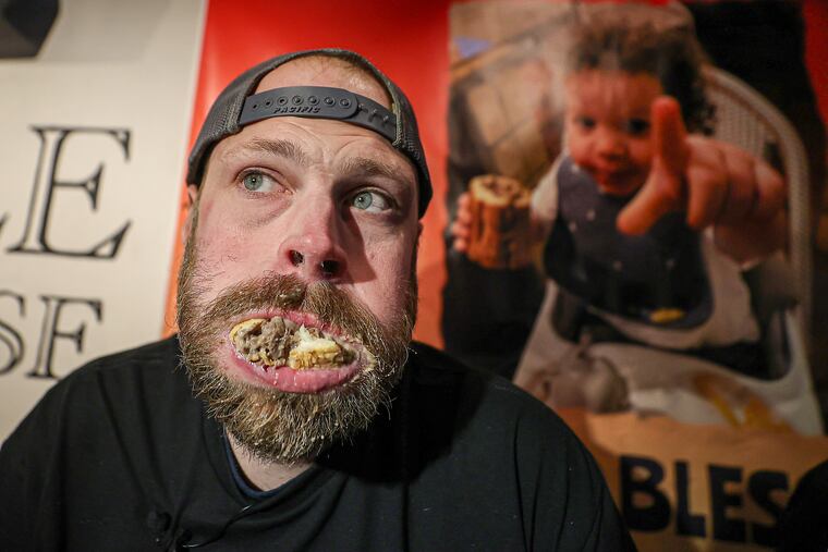 Dan Kennedy, of West Decatur, Pa., tries to finish the last of seven and a half cheesesteaks at the Marple Public House in Broomall on Sunday.