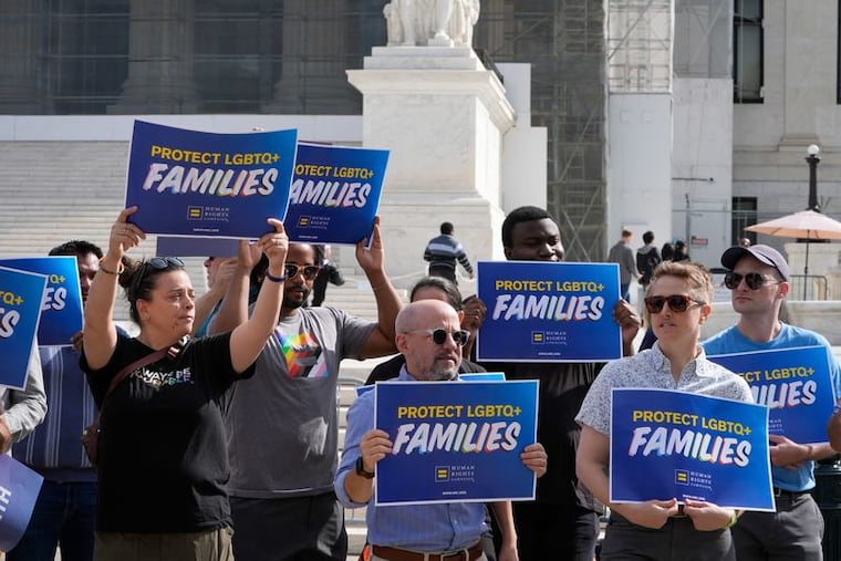 Protesters rally outside the U.S. Supreme Court Building this month as the justices hear oral arguments on whether Colorado's ban on providing conversion therapy to LGBTQ+ children violates a private therapist's rights to free speech.
