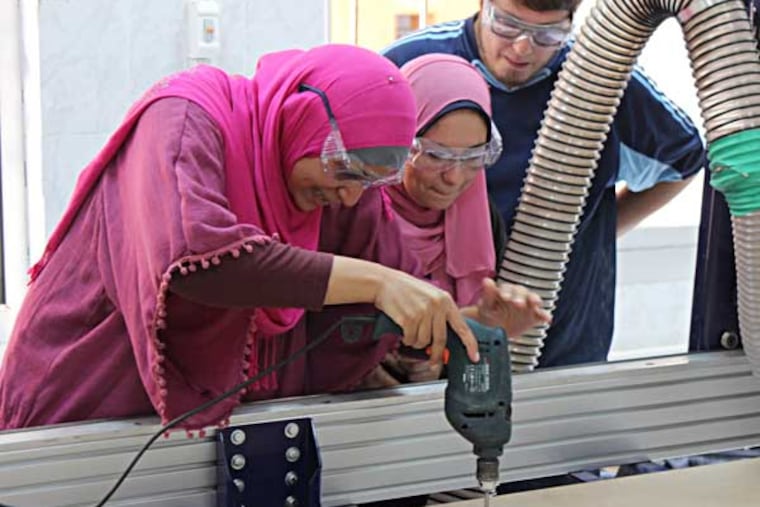 Students from the Maadi STEM Schools for Girls prepare to use their Fab Lab's Shopbot to cut a standing desk they helped design. Photo courtesy: Justin Duffy