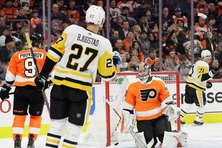 Flyers goaltender Carter Hart reacts after Pittsburgh Penguins center Nick Bjugstad scored a second-period goal Monday.