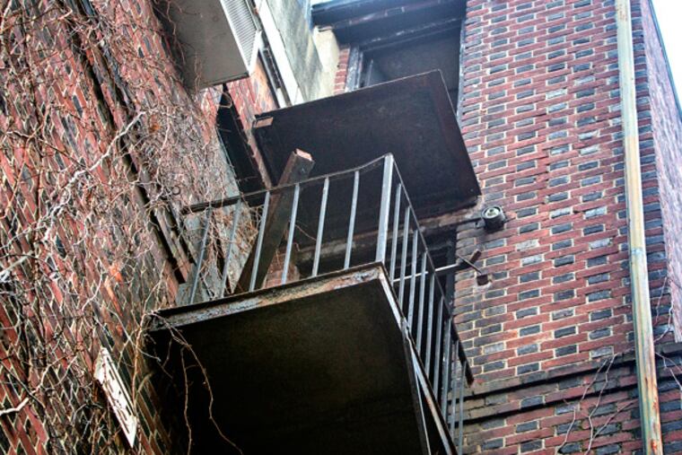 Tragedy struck early Sunday when a 3rd-floor balcony collapsed at the John C. Bell House, a historic house at 229 S. 22nd St., sending three people to the pavement below. One victim has died and two were listed in critical condition. This is a view looking up with debris on the 2nd floor balcony and the missing railing on the 3rd floor balcony. (ED HILLE/Staff Photographer)
