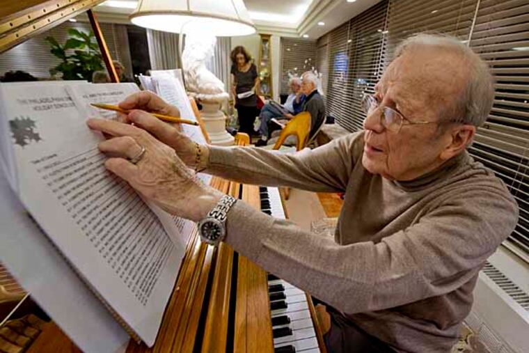 Harry Gartzman, 93, makes a notation on a song during a practice session Dec. 6, 2012 for the upcoming Christmas carols singalong at The Philadelphia condo complex on Dec. 19. Gartzman recovered from a stroke thanks to his love of music and playing the piano. ( CLEM MURRAY / Staff Photographer )