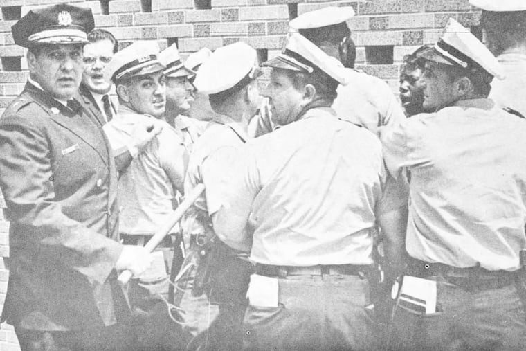 Then-police commissioner Frank Rizzo, with club, leading police beating a Black girl demonstrator at State Office Building, Broad and Spring Garden Streets in an undated photograph.