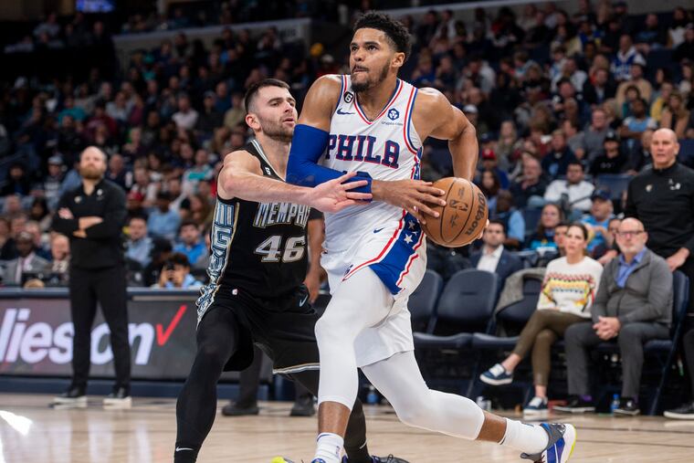 Sixers forward Tobias Harris, right, drives against Memphis Grizzlies guard John Konchar in an NBA basketball game Friday, Dec. 2, 2022, in Memphis, Tenn.