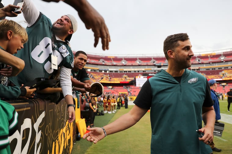 Eagles coach Nick Sirianni meets with happy fans after the victory over the Commanders at FedEx Field.
