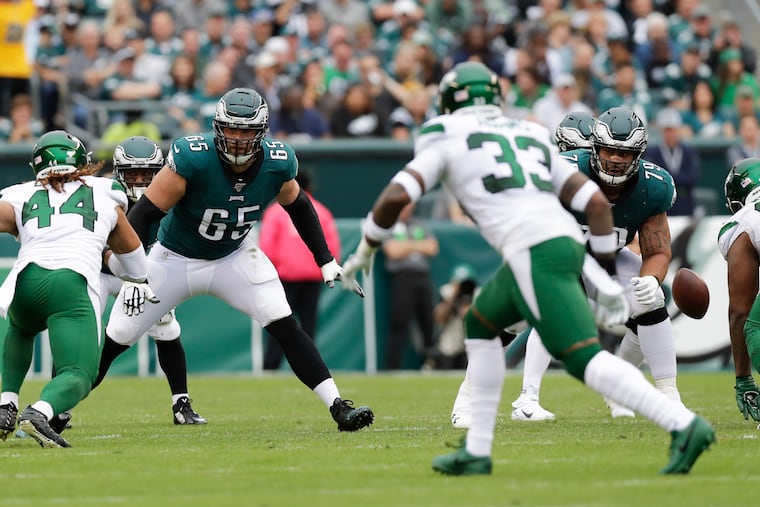 Eagles offensive linemen Lane Johnson and Brandon Brooks watch New York Jets linebacker Harvey Langi (left) and strong safety Jamal Adams (33) during Sunday's game.