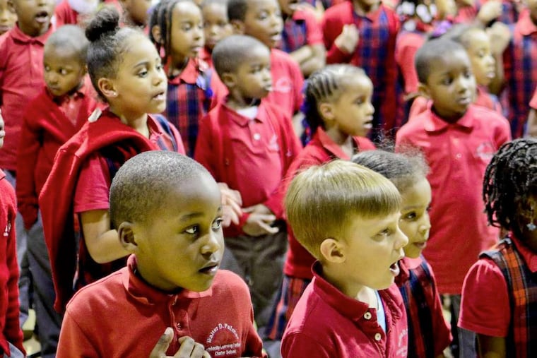Students at an assembly in Philly's Walter D. Palmer charter. The proliferation of charter schools in Pennsylvania and New Jersey has both states upgrading their laws.