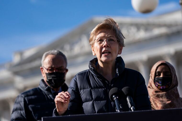 Flanked by Senate Majority Leader Chuck Schumer (D-NY) and Rep. Ilhan Omar (D-MN), Sen. Elizabeth Warren (D-MA) speaks during a press conference about student debt outside the U.S. Capitol on Feb. 4, 2021, in Washington, DC.