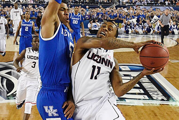 Connecticut guard Ryan Boatright shoots as Kentucky guard Andrew Harrison defends. (Chris Steppig/AP)