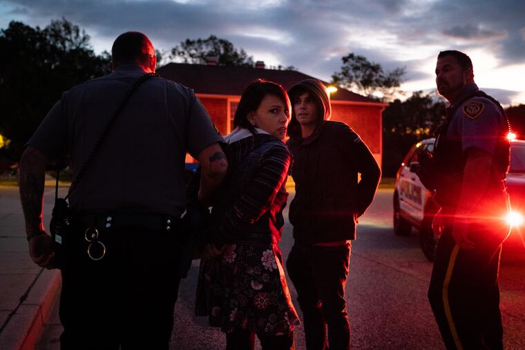 Teen actors rehearse a drug bust scene with police officers for the Haunted Trap House.