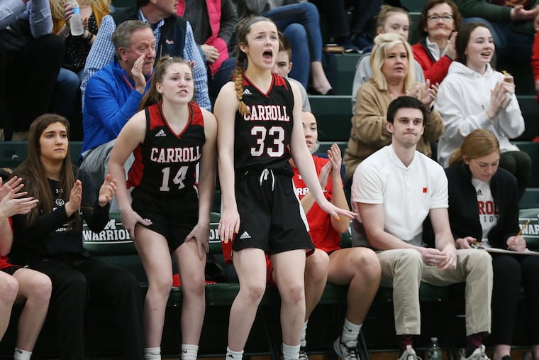 Archbishop Carroll's Meg Sheridan (14) and Rose Henry (33) cheer after their team made a basket in March during their PIAA Class 5A first-round playoff game against Mount St. Joseph at Methacton High School.