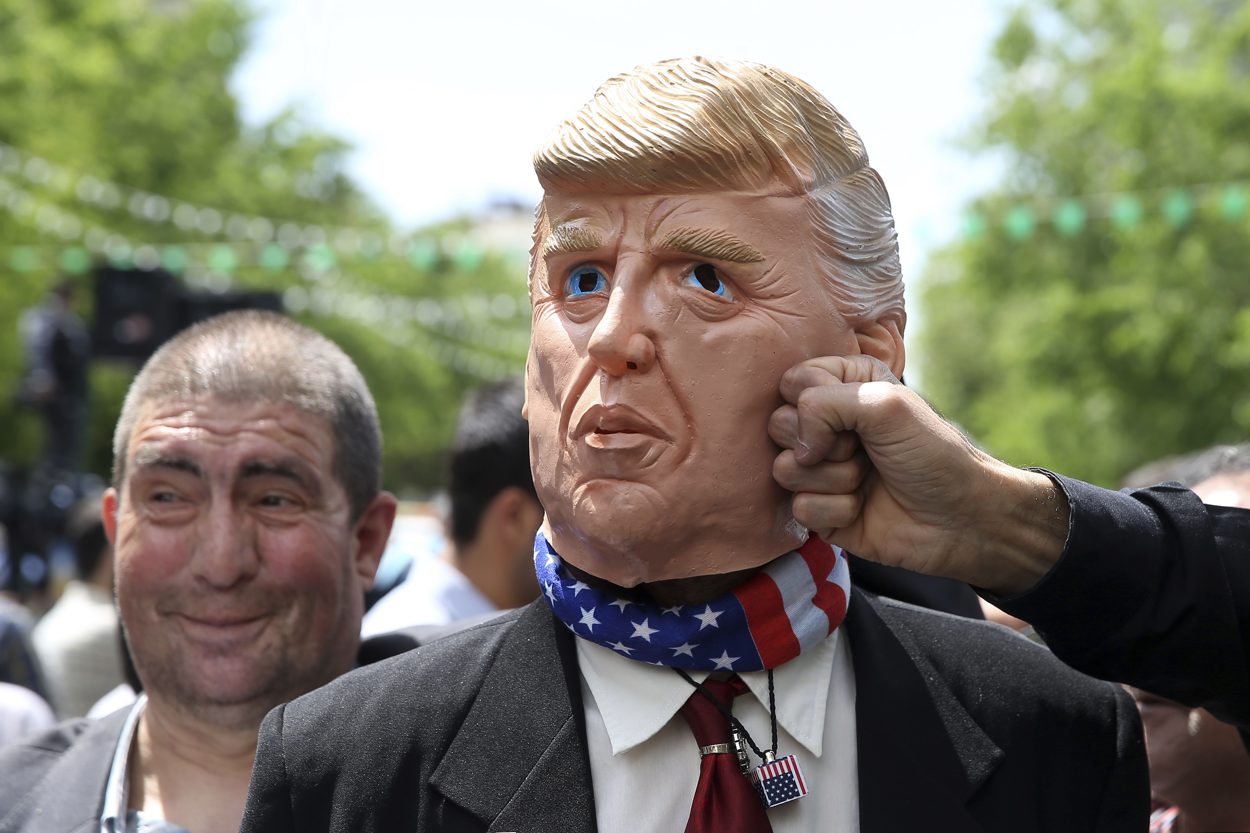An Iranian protester pretends to punch a mask mocking President Donald Trump during a rally after Friday prayer in Tehran, Iran, Friday, May 10, 2019. A top commander in Iran's powerful Revolutionary Guard said Friday that Tehran will not talk with the United States, an Iranian news agency reported — a day after President Donald Trump said he'd like Iranian leaders to "call me."