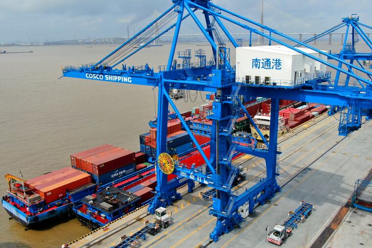 Shipping containers are loaded onto a cargo ship at a port in Nantong in eastern China's Jiangsu province on July 18, 2019. Beijing appealed to Washington on Wednesday, Aug. 21, to "meet China halfway" and end a tariff war after President Donald Trump said Americans might need to endure economic pain to achieve longer-term benefits.