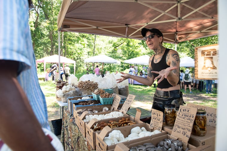 Val Ray King interacts with a customer at the Philadelphia Mycology Club’s second annual Fungadelphia Festival at the Schuylkill Center for Environmental Education in Philadelphia on Saturday, Aug. 23, 2025. King was running a booth for the Mycopolitan Mushroom Company.