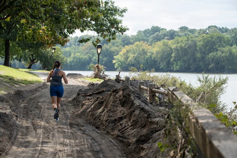 Piles of sand and debris surround the Schuylkill River Trail near the Columbia Train Bridge in Philadelphia, Pa. on Wednesday, September 8, 2021. The remnants of Hurricane Ida caused significant flooding along the popular running and biking trail.