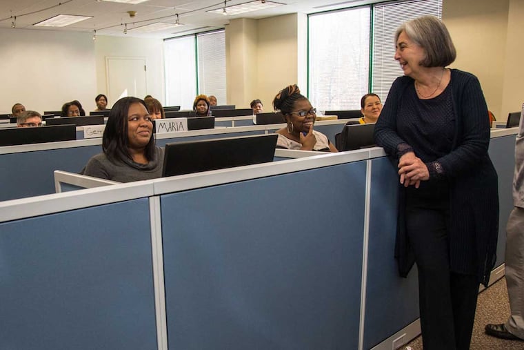 Claudia Timbo talks to one of the staffers for her business CompanyVoice, which provides call center services for various clients.