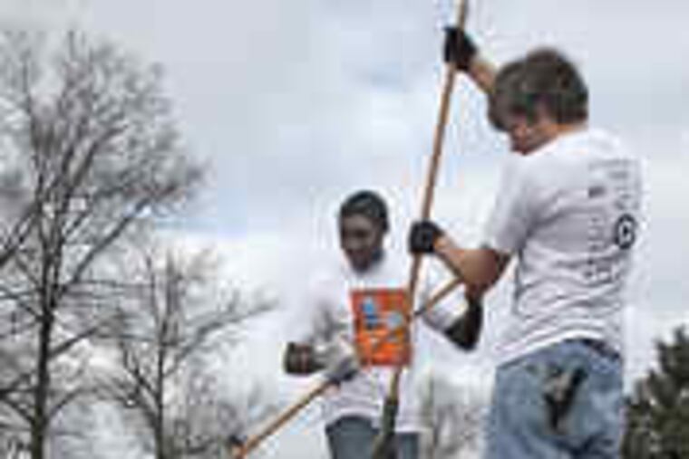 The rakes' progress: Service went to the head of the class in Burlington City, where Doane Academy juniors McKel Hyppolite (left) and Ben Gross cleaned up JFK Park.