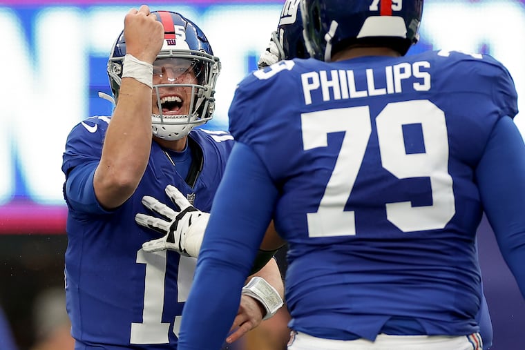 New York Giants quarterback Tommy "Cutlets" DeVito uses a popular Italian gesture to celebrate after throwing a touchdown pass against the New England Patriots last month. (AP Photo/Adam Hunger)