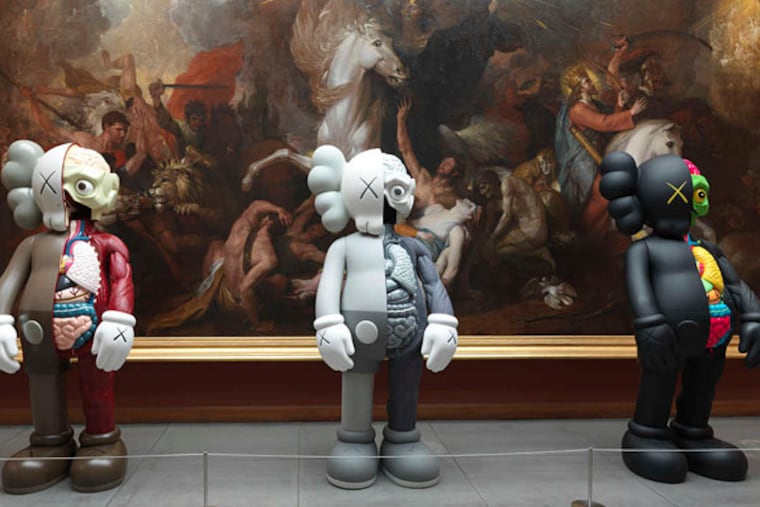 At the Pennsylvania Academy of the Fine Arts, three "Companion" figures by KAWS stand guard before Benjamin West's 1817 painting "Death on the Pale Horse."