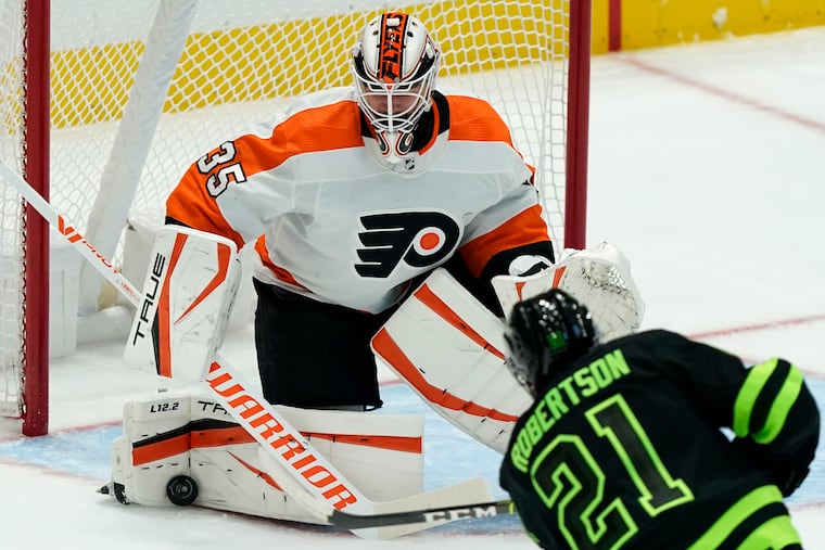 Philadelphia Flyers goaltender Martin Jones (35) defends the goal against Dallas Stars left wing Jason Robertson (21) during the first period of an NHL hockey game in Dallas, Saturday, Nov. 13, 2021. (AP Photo/LM Otero)