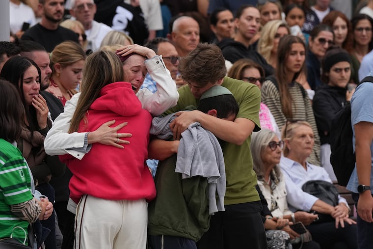 Family members of a victim from Sunday's shooting mourn at a flower memorial made after the shooting at Bondi Beach on Tuesday, Dec. 16.