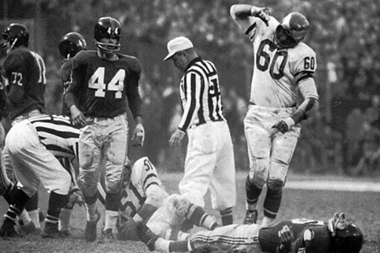 Chuck Bednarik stands over a laid out Frank Gifford. (File photo)