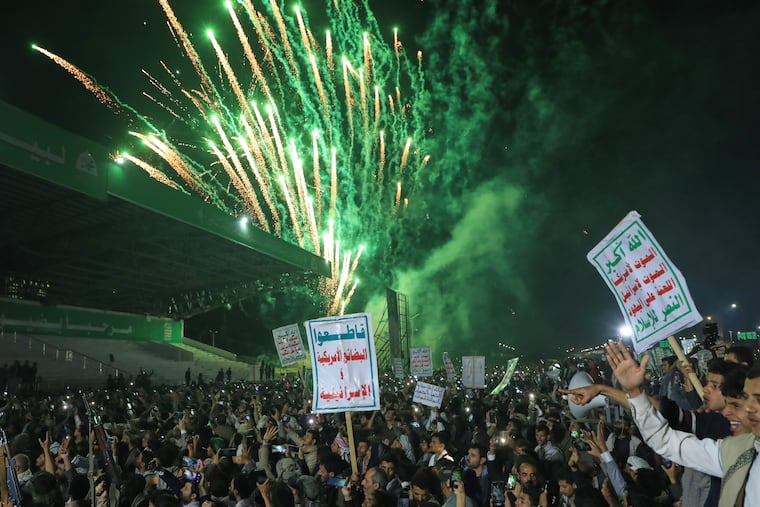 Fireworks burst as Houthi supporters rally against the Saudi-led coalition in Sanaa, Yemen, Monday, July 20, 2026. Placards in Arabic read: "God is great, Death to America, Death to Israel, A curse on the Jews and Victory to Islam" and "boycott American and Israeli goods".