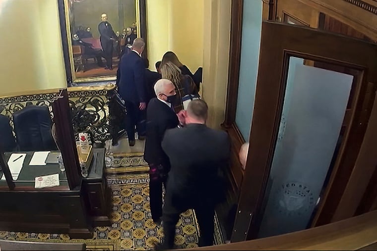 In this image from video, a security video shows Vice President Mike Pence being evacuated from near the Senate chamber as rioters breach the Capitol, on Jan. 6, 2021.