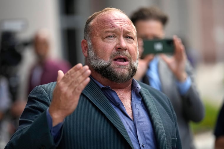 Right-wing conspiracy theorist Alex Jones speaks to the media after arriving at the federal courthouse for a hearing in front of a bankruptcy judge in Houston, June 14, 2024.