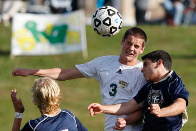 La Salle's Jack Dusing (left) and Don Naseef (right) battle Lansdale Catholic's Brendan Pinder for the ball. Explorers coach Bob Peffle said Lansdale has played tough all year.