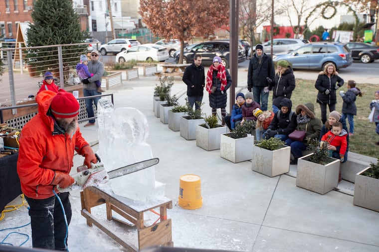 People watch an ice sculpture carving demonstration at the Lutheran Settlement House Saturday, December 8, 2018. Many in the Fishtown community have rallied to support the house. MARGO REED / Philadelphia Inquirer