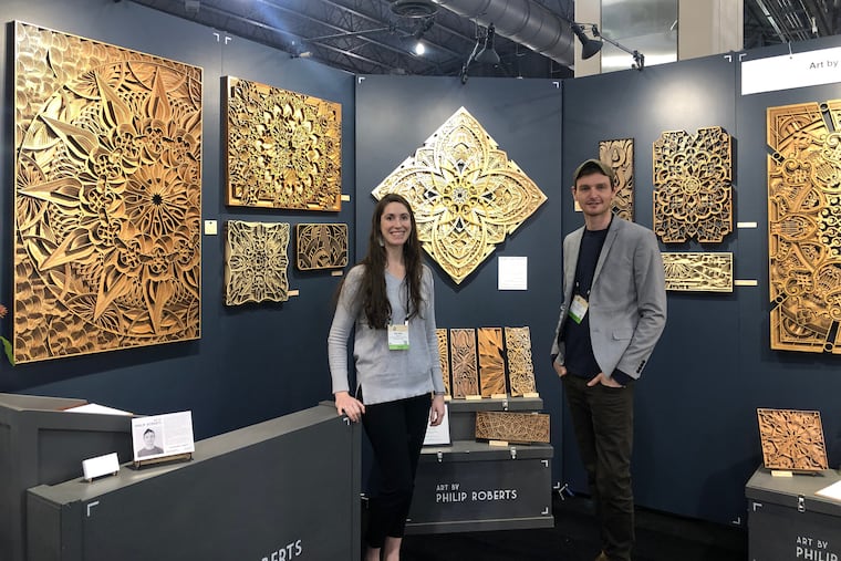 Phillip Roberts and his wife Melinda Roberts standing at their booth at this American Handcrafted Philadelphia show at Pennsylvania Convention Center.