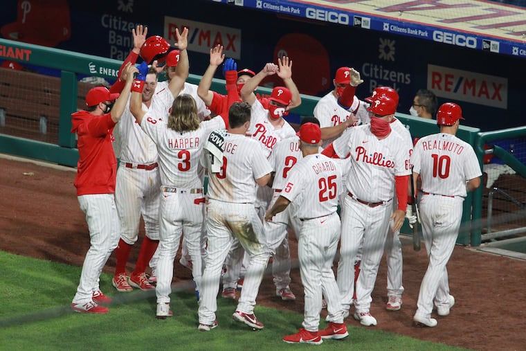 The Phillies, seen here celebrating a victory on Aug. 14, hope to do more of it in the postseason.