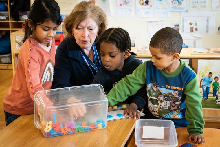 (From left) Israt Uddin, assistant teacher Patty Rowley, Hajj Williams, and Albert Sanchez-Cruz, at the Kinder Academy in Philadelphia.