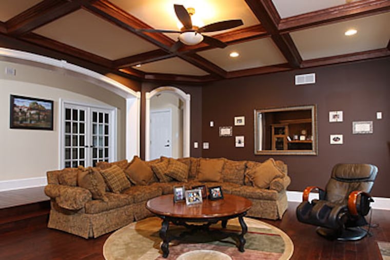 Danny Brière credits wife Sylvie with most of the decorating in their home's spacious family room, but he picked out the big sectional. (Michael Bryant/Staff Photographer)