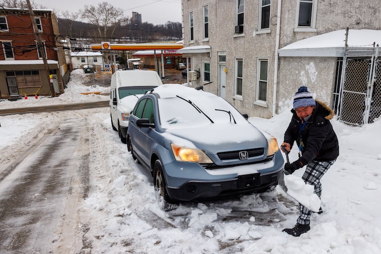 Connor Phan digging out his car in East Falls on Monday, Jan. 26, 2026.