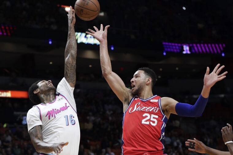 Ben Simmons has his shot blocked by Heat forward James Johnson (left) in the Sixers’ loss on Thursday.