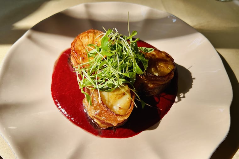 Bacon-wrapped scallops in blackberry aigre-doux is an appetizer at Rockwell & Rose, 601 Walnut St.
